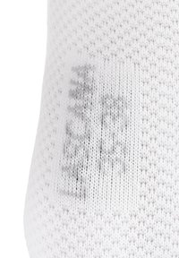 White sock with a textured knitted pattern, featuring subtle gray printing. Material appears soft and stretchy, designed for comfort.