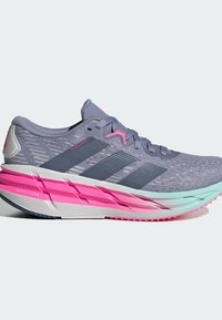 Sport shoes in grey and pink with a textured upper, three black stripes, cushioned midsole, and a patterned sole for grip.