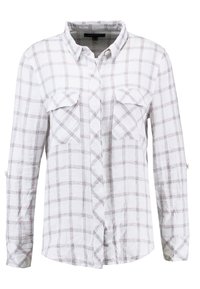 Chemise à manches longues à carreaux blancs et rouge clair, dotée de deux poches poitrine et d'un col boutonné. Tissu léger avec une coupe décontractée.