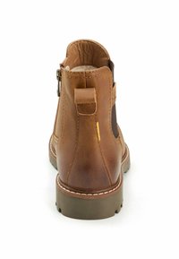 Brown leather ankle boot with elastic side panels, a looped back tab, and a textured sole. Features visible stitching and a smooth finish.