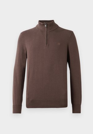 Bruine gebreide pullover met een hoge kraag en een kwart rits. Voorzien van geribbelde mouwen en onderrand, met een klein logodetail op de borst.