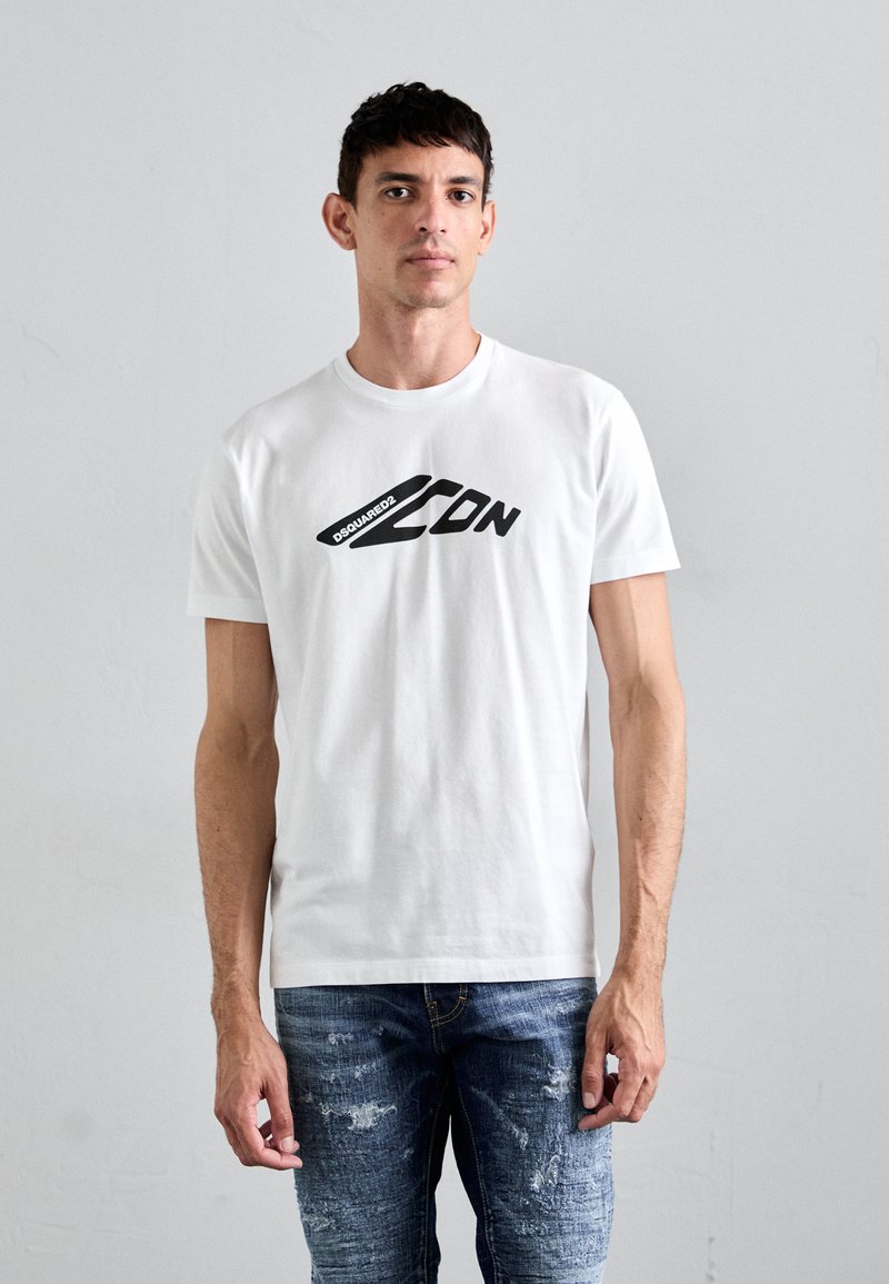 White cotton t-shirt with black graphic text "DSQUARED2 ICON" across the chest; short sleeves, crew neck, and relaxed fit. Worn with distressed jeans.