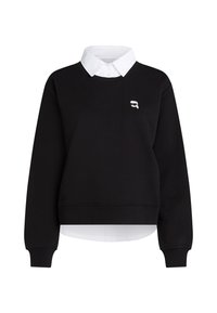 Svart sweatshirt med en vit skjortkrage och fåll, med en liten logotyp på bröstet. Tillverkad av mjukt material, med långa ärmar.