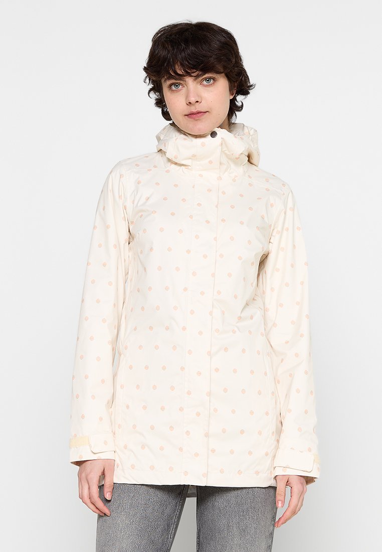 Licht beige waterdichtejas met capuchon, voorzien van een subtiel stippenpatroon in zacht perzik. Slanke pasvorm en lange mouwen met verstelbare manchetten.