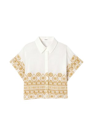 Chemise blanche à manches courtes boutonnée avec col pointu, présentant des motifs floraux et géométriques jaunes sur les manches et la partie inférieure.