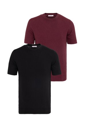 Deux pulls à manches courtes avec col rond, un noir devant et un bordeaux derrière, présentés sur un fond blanc.