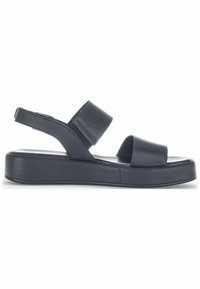 Sandales à lanières arrière noires avec larges brides et semelle plate. Texture en cuir lisse et design minimaliste pour plus de confort et de stabilité.