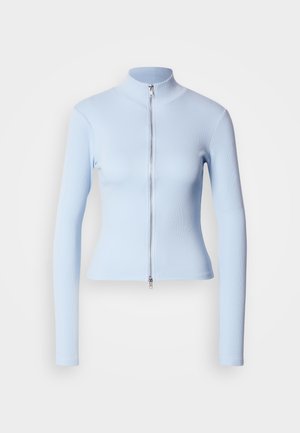 Lyseblå langermet topp med høy krage og frontglidelås, laget av ribbestrikket stoff, tettsittende design, jevn tekstur og minimalistisk stil.