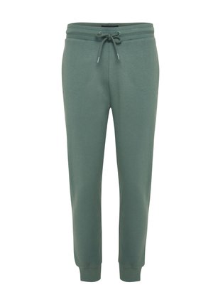 Zielone bawełniane spodnie dresowe z regulowanym sznurkiem w pasie, zwężanymi nogawkami i ściągaczami przy mankietach, zapewniające miękką i wygodną fakturę.