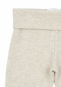 Beige texturerade leggings med en vikbar midja, som har ett subtilt våffelmönster och ett mjukt, lätt tyg.