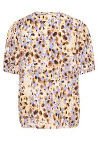 T-shirt à manches courtes et col ras du cou en tissu léger, avec un fond beige parsemé de taches abstraites marron et bleues.