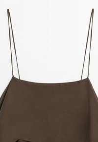 Sleeveless brown top with thin spaghetti straps and a straight neckline, displayed against a white background.