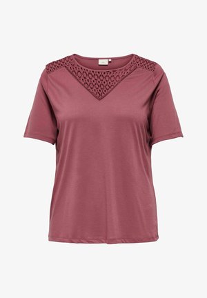 Marlon majica kratkih rukava izrađena od glatkog materijala s čipkastim V-izrezom. Opusten kroj s ravnim rubom.