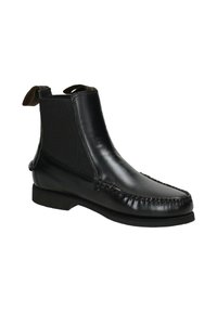 Stivale Chelsea in pelle nera con pannelli elastici ai lati, cuciture decorative, punta tonda e tacco basso impilato.