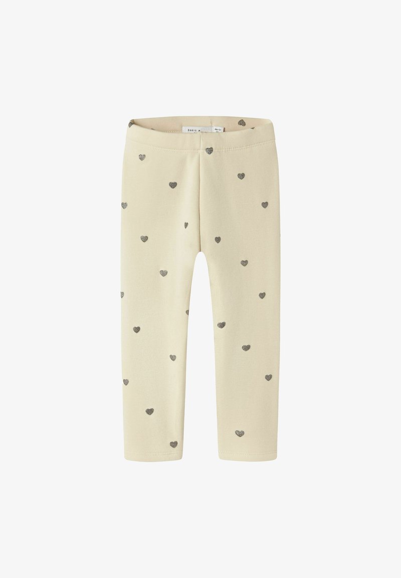 Krēma krāsas mazuļu legingi ar izkaisītiem maziem sudraba sirds rakstiem, elastīga josta un pilna garuma kājas.