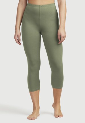 Olivgrüne Capri-Leggings aus einem dehnbaren, gerippten Stoff mit einem elastischen Bund, die sich glatt am Körper über den Knöcheln anpassen.