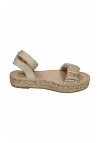 Beige espadrille sandal with an elasticized strap and braided jute sole; smooth texture with a flat footbed and minimalist design.
