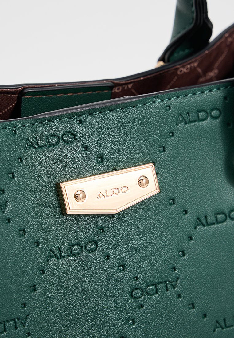 Sac à main synthétique texturé vert avec le logo « ALDO » en relief, plaque en métal doré et doublure intérieure brun foncé.