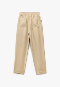 Pantalones beiges con cintura elástica y dos bolsillos traseros. Tela suave, diseño de pierna recta y costuras sencillas para un acabado limpio.