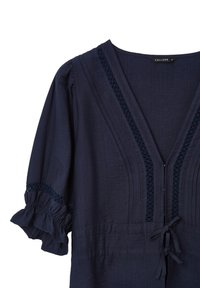 Navy blue blouse with short, ruffled sleeves, woven details along the V-neckline, and a tie at the waist. Made from lightweight fabric.