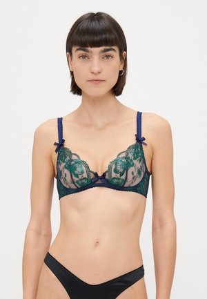 Lace bra with sheer navy fabric and green floral embroidery, featuring two small bows on the straps, and a scalloped trim along the edges.