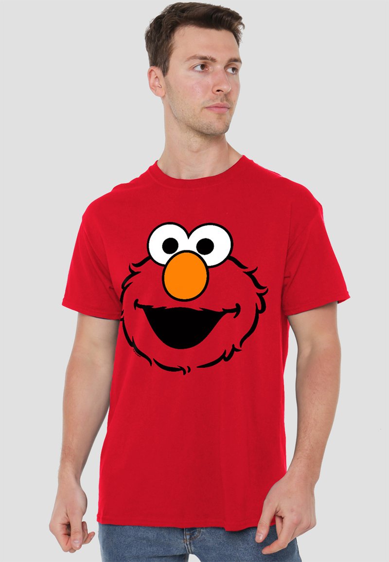 Red cotton t-shirt featuring a large, black outline graphic of a cartoon character's face with white eyes and an orange nose.