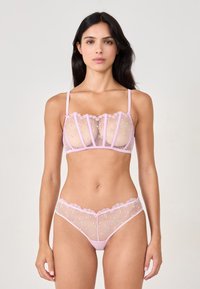 Pink transparent lingerie set with floral embroidery. Bralette features structured cups and lace trim; matching thong has lace edges.