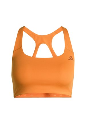 Oranžová sportovní podprsenka s kulatým výstřihem a křížovým designem na zádech. Vyrobena z elastického materiálu, s logem na levé straně.