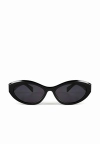 Black sunglasses with an angular cat-eye frame, glossy finish, and dark lenses. Distinctive, wide temples and a streamlined design.