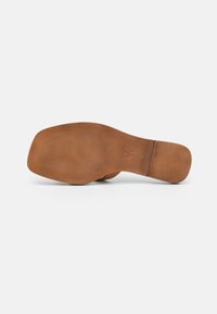 Brown shoe sole with a smooth texture and subtle grip patterns. Features a contoured shape and rounded edges. No visible logos.
