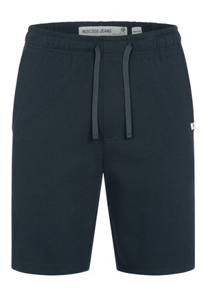 Shorts bleu foncé jusqu'aux genoux avec une taille élastique, une fermeture à cordon de serrage et une petite étiquette logo blanche sur le côté.