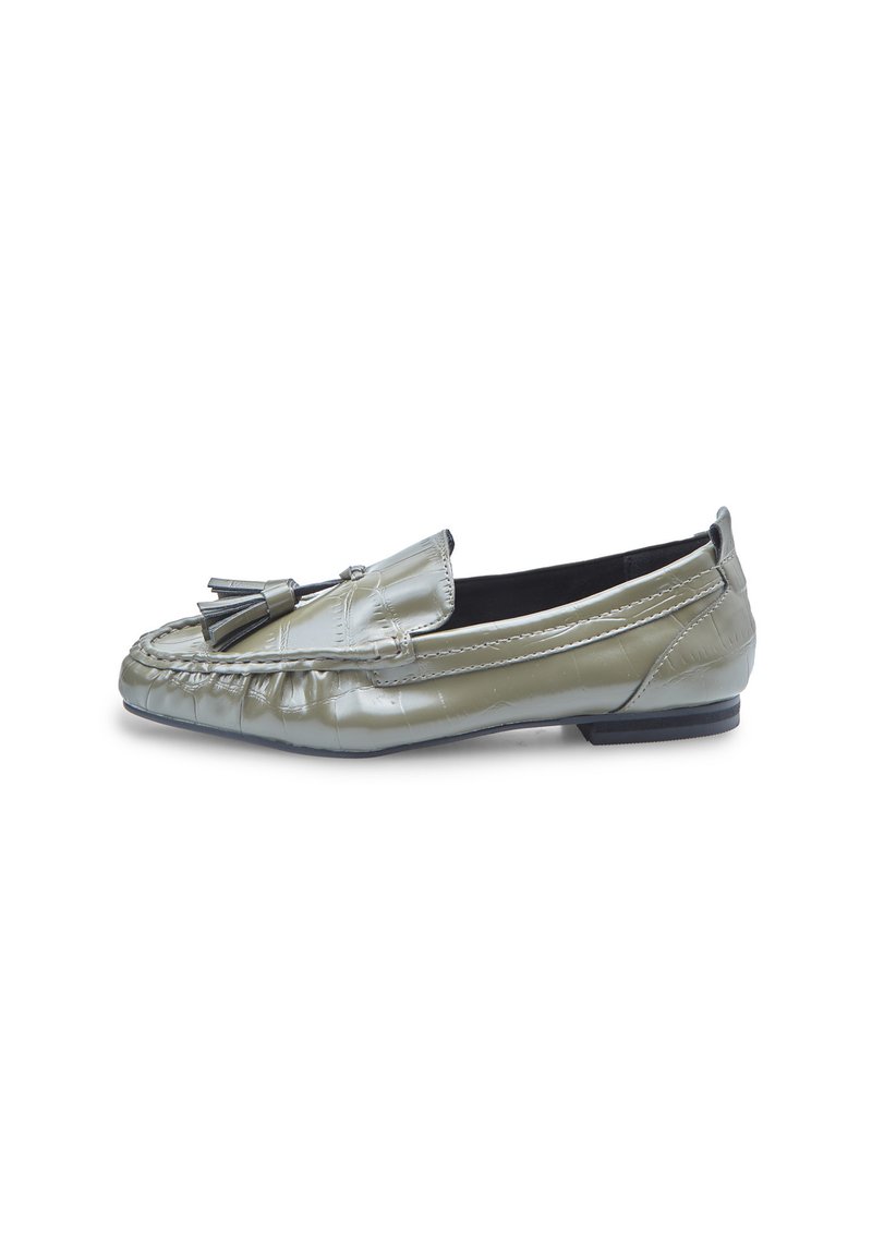 Mocassin en cuir vert olive avec des franges sur le dessus, des détails de couture et un petit talon noir, présenté de côté sur un fond blanc.
