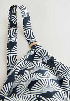 Tumesin bikiinitop, millel on valge fännimuster, reguleeritavad rihmad ja kuldse tooni aksent. Pehme kangas sileda tekstuuriga.