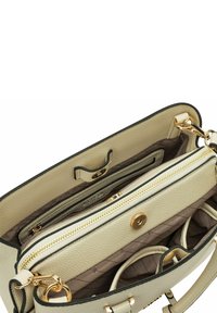 Beige textured leather handbag with gold hardware, zip compartments, and a brown lined interior featuring multiple pockets.