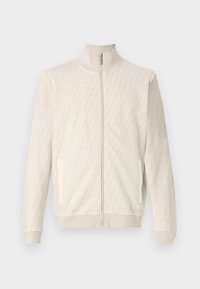 Veste zippée beige clair avec un motif géométrique texturé, col et poignets côtelés, et deux poches latérales.