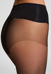 Zwarte hoge taille panty met een doorschijnend, gestructureerd ontwerp dat overgaat in een huidkleurige tint, wat een gladde, naadloze uitstraling benadrukt.