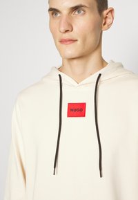 HUGO DARATSCHI - Sweatshirt com capuz - natural
