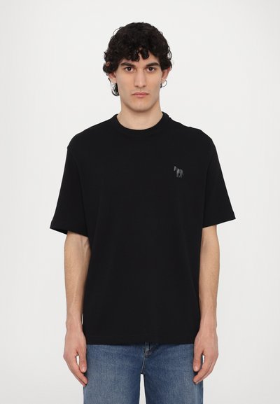 Black crewneck t-shirt made of cotton, features short sleeves and a small gray horse graphic on the left chest. Smooth texture, relaxed fit.