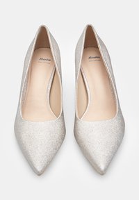 Sudraba mirdzoši augstpapēžu apavi ar smailu purngalu, izgatavoti no īstas ādas, ar gludu iekšējo oderi un elegantu dizainu.