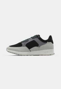 Black and gray athletic shoes with a mesh upper, smooth rubber outsole, green laces, and CLAE branding on the heel.