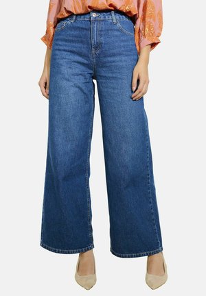 Wide-leg blue denim jeans with high waist, classic five-pocket style, and subtle stitching details. Smooth texture and loose fit.