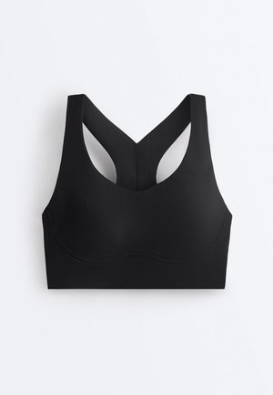 Črni športni modrček brez šivov s širokimi naramnicami in zadnjim delom v obliki dirkaškega hrbta, izdelan iz gladkega, raztegljivega materiala za podporo in udobje.