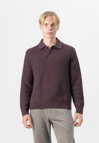 Maroon knit sweater with a textured pattern, three-button placket, and a collared neckline, worn over light gray corduroy pants.