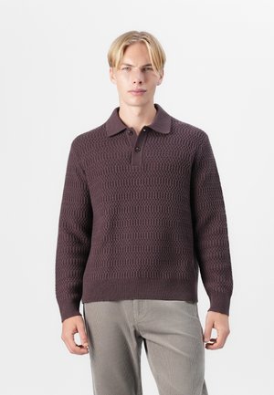 Maroon knit sweater with a textured pattern, three-button placket, and a collared neckline, worn over light gray corduroy pants.