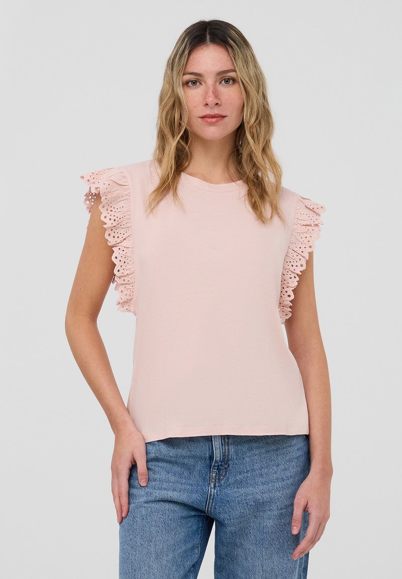 Top rosa chiaro a maniche corte con accenti di pizzo arricciato sulle spalle. Realizzato in tessuto morbido, presenta un collo girocollo e una vestibilità comoda.