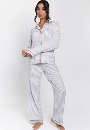Striped gray pajama set with red accents. Features long sleeves, button-down front, and pocket detail. Soft, smooth fabric texture.