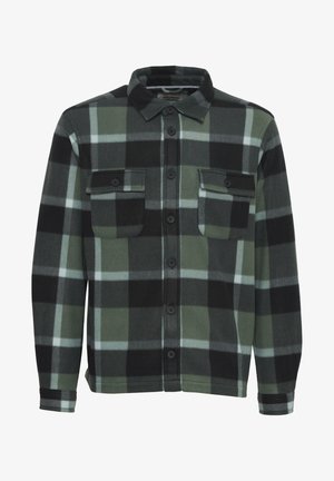Chemise en flanelle à carreaux verts et noirs avec deux poches poitrine, fermeture à boutons et col. Tissu doux avec une texture lisse.