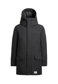 Černá zimní parka s kapucí, přední zip zakrytý légu, dvě šikmé náprsní kapsy, dvě spodní kapsy s légy a malá bílá cedulka blízko spodního okraje.