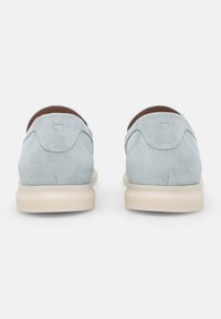 Scarpe in suede blu chiaro con design arrotondato, dotate di suola in gomma beige e semplici dettagli di cucitura sul tacco.