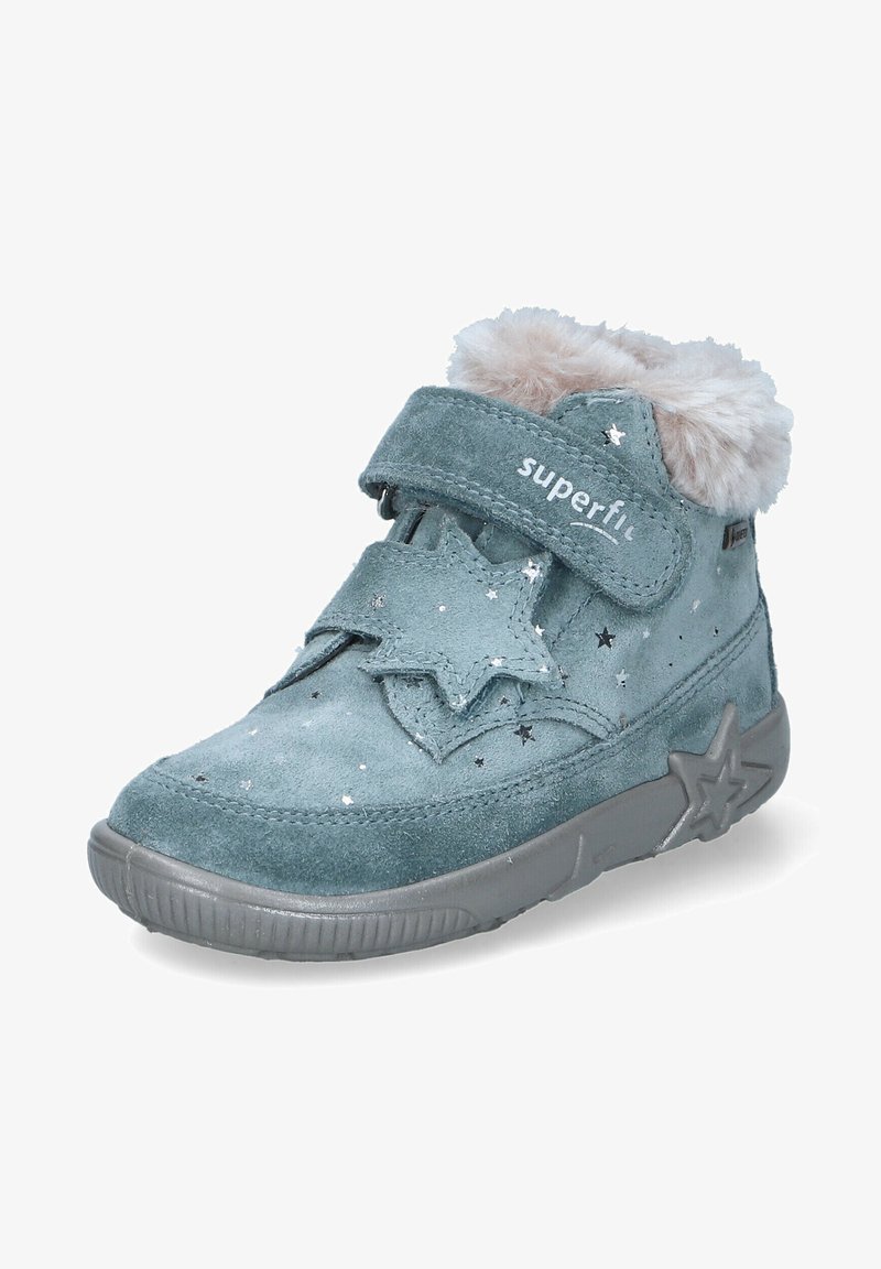 Samtově modré kotníkové boty s šedou gumovou podrážkou, hvězdnými akcenty a kožíškovým límcem. Na vrchu je suchý zip pro bezpečné upevnění. Stříbrné hvězdné vzory.